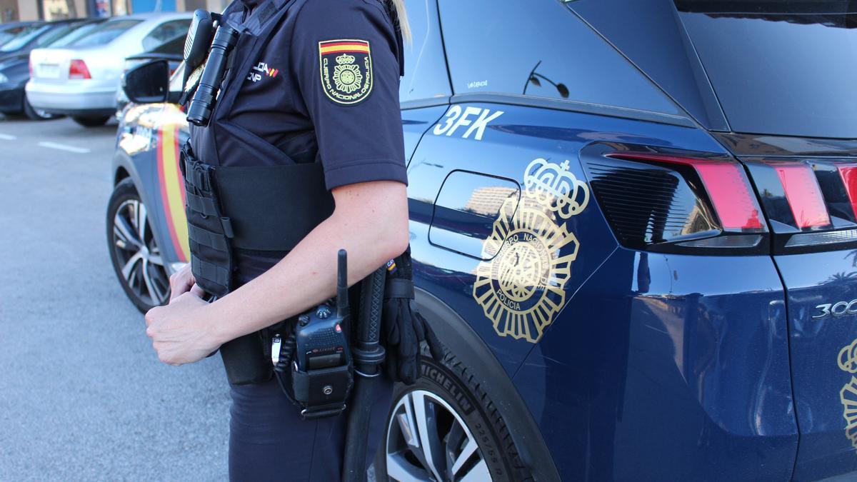 Un agente de la Policía Nacional junto a su vehículo. Un agente de la Policía Nacional junto a su vehículo.