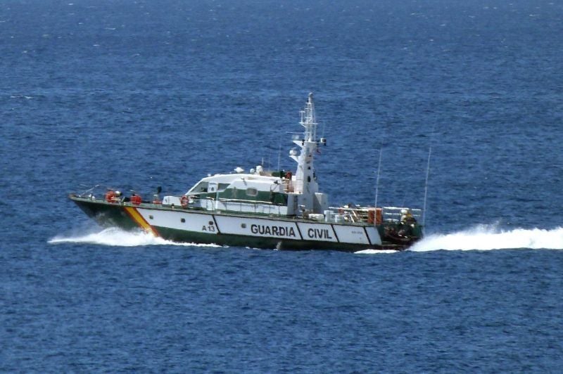 Una patrullera de la Guardia Civil, auxiliada por un helicóptero para no acabar hundiéndose
